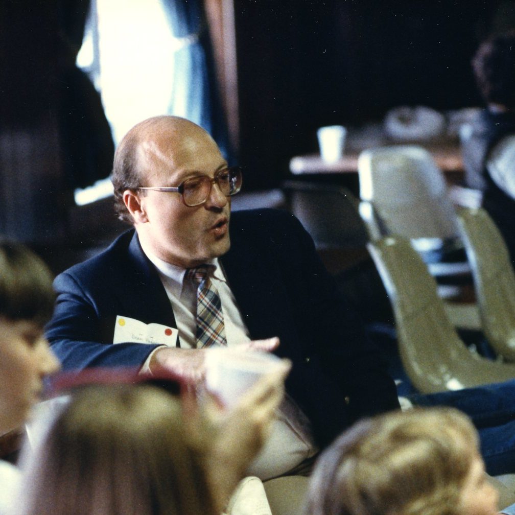Dean Hughes seated amongst children
