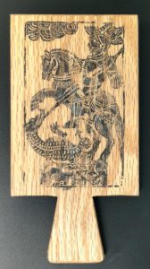 English style hornbook with engraving of St. George and the dragon on its back.