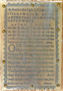 Close-up of hornbook showing imperfection of the genuine horn that obscures the text beneath it.