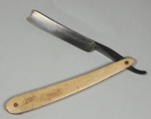 This folding straight razor with a bone handle (MH.6.49) was used to shave.